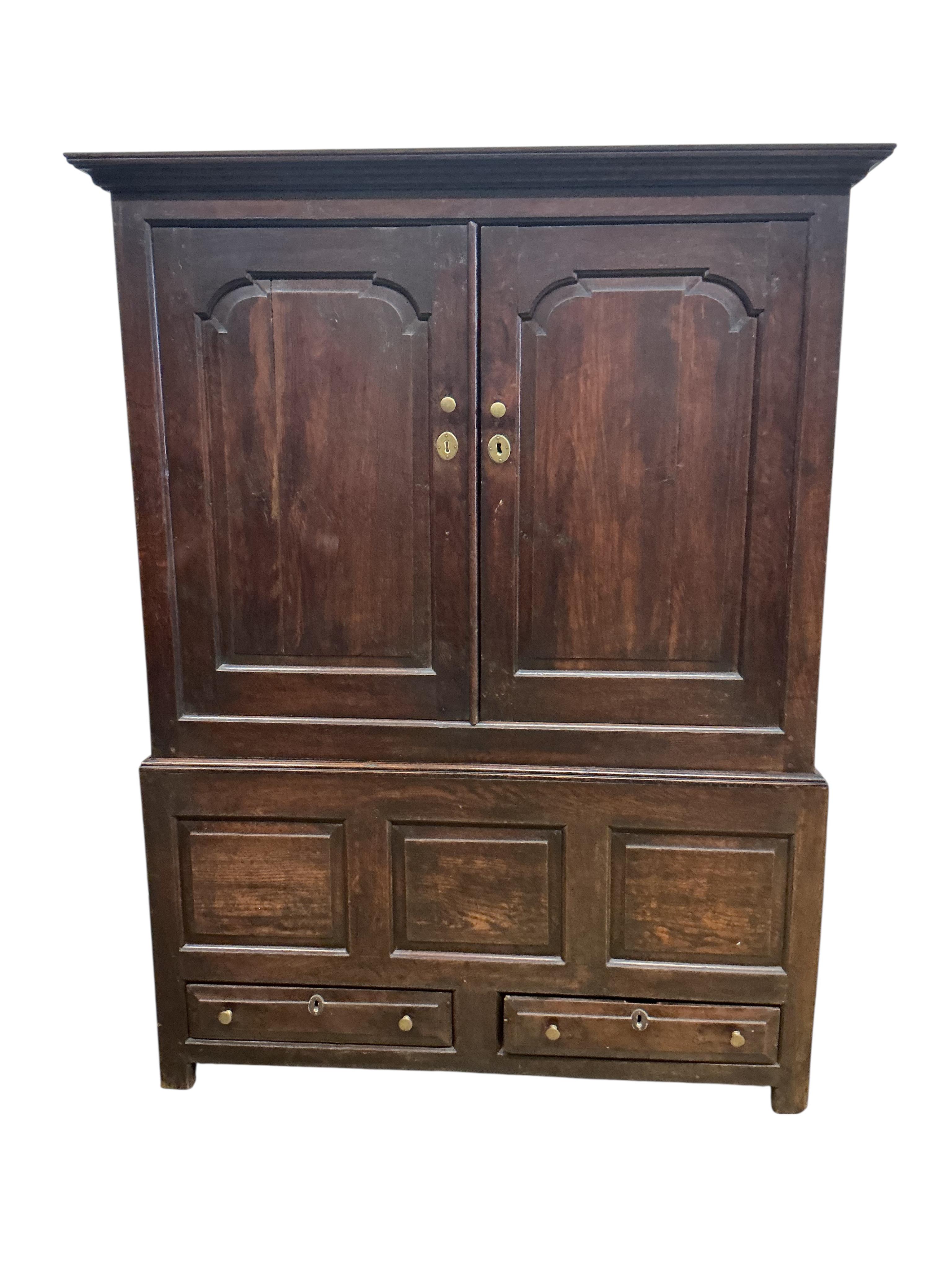 An 18th century oak two part hanging cupboard, width 139cm, depth 55cm, height 181cm